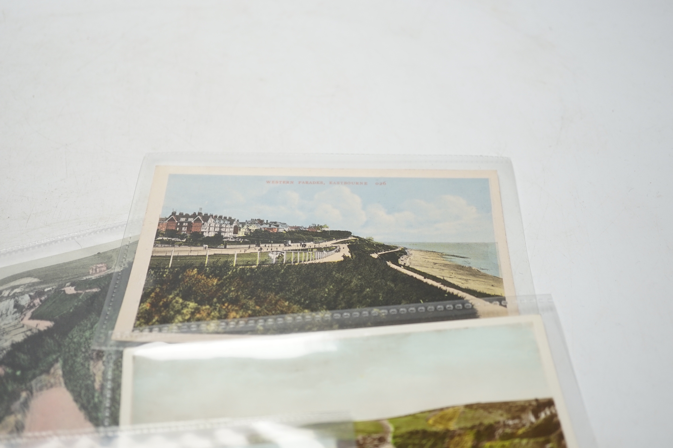 A large quantity of early to mid 20th century postcards of Eastbourne and the surrounding area, all in individual protective sleeves (in two boxes)